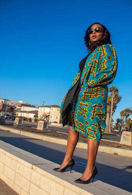 "Ankara" is the common name for a type of cotton cloth featuring brightly coloured patterns, associated especially with West African fashion.  Long puff sleeve midi length robe with front pockets  Handmade and 100% cotton.