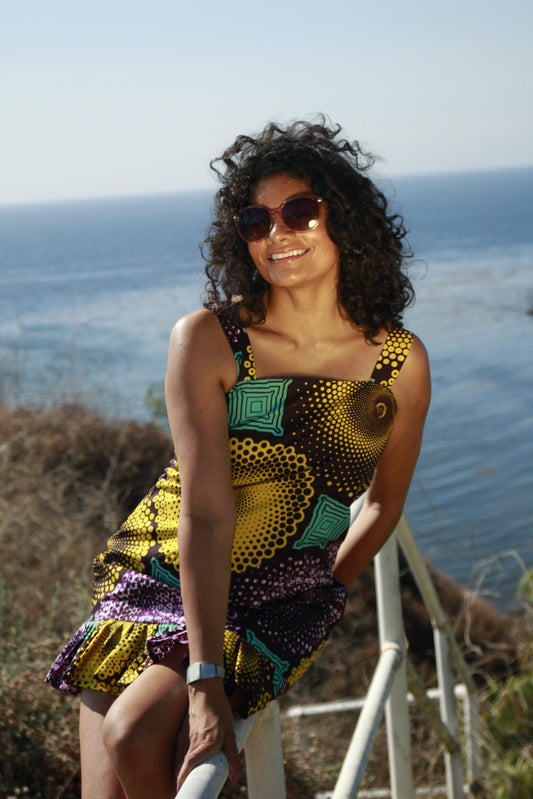 "Ego" is the Nigerian Igbo word for "money" or "wealth."  Big strap, fitted mini dress with a pleated hem.   100% cotton.