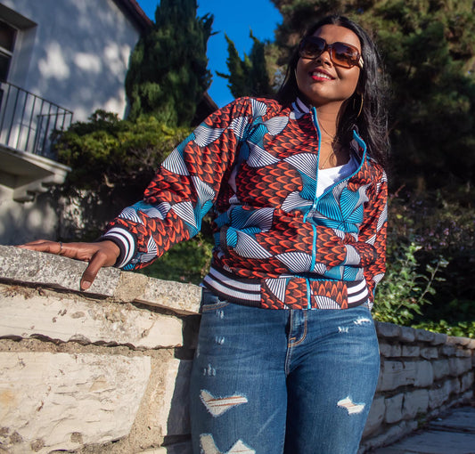"Kene" is a Nigerian Igbo word meaning "thank"; used to express gratitude or appreciation.   Bomber jacket with black/white ribbed trim neck, cuffs and bottom; side pockets and zip closure.  100% Cotton