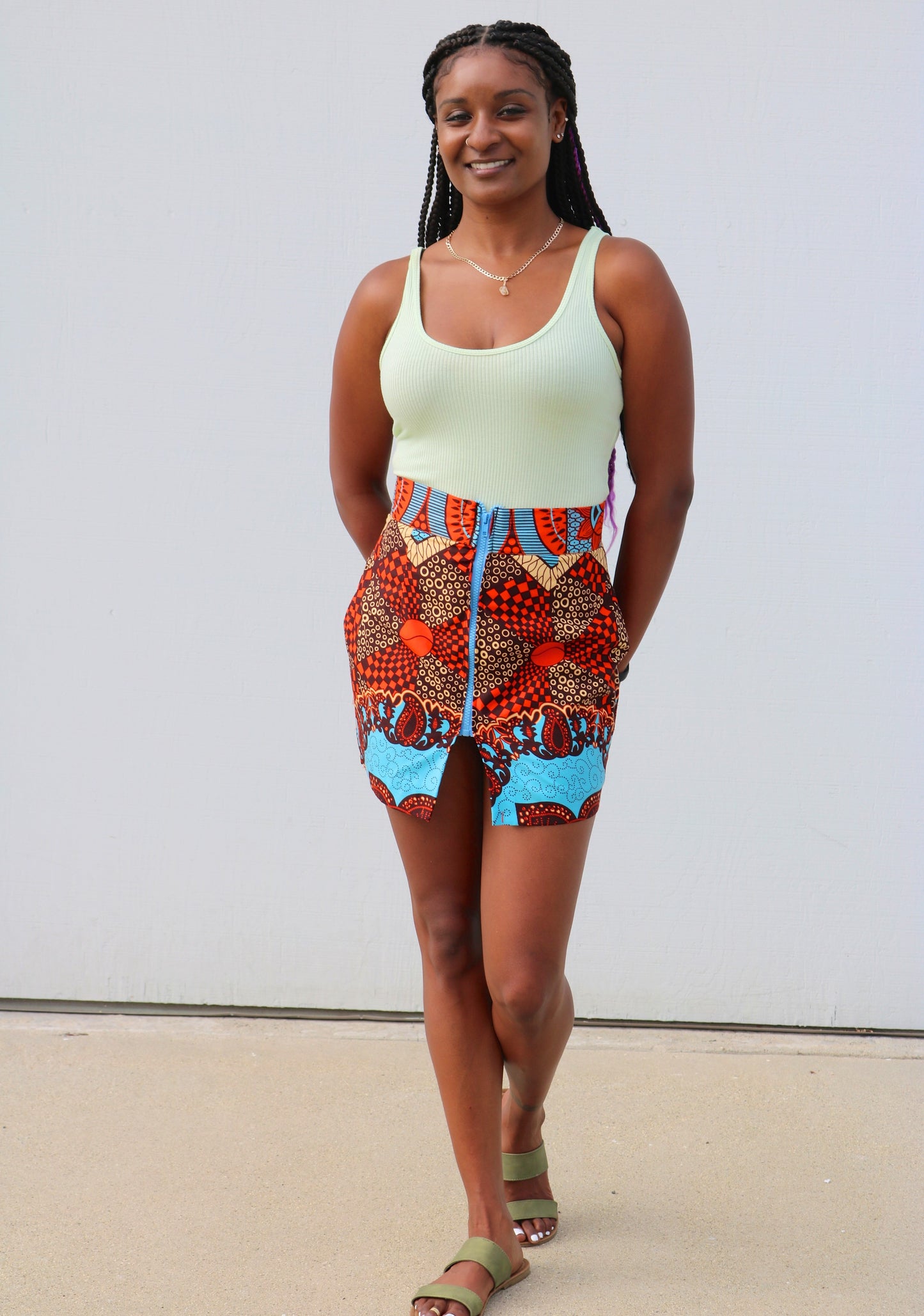 "Nlecha" is the Nigerian Igbo word for "show off."  Miniskirt with a blue zipper in front.  100% cotton.